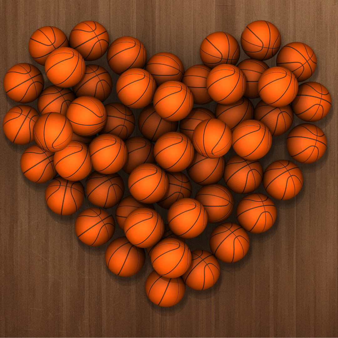Basketballs arranged in a heart shape on a wooden floor.