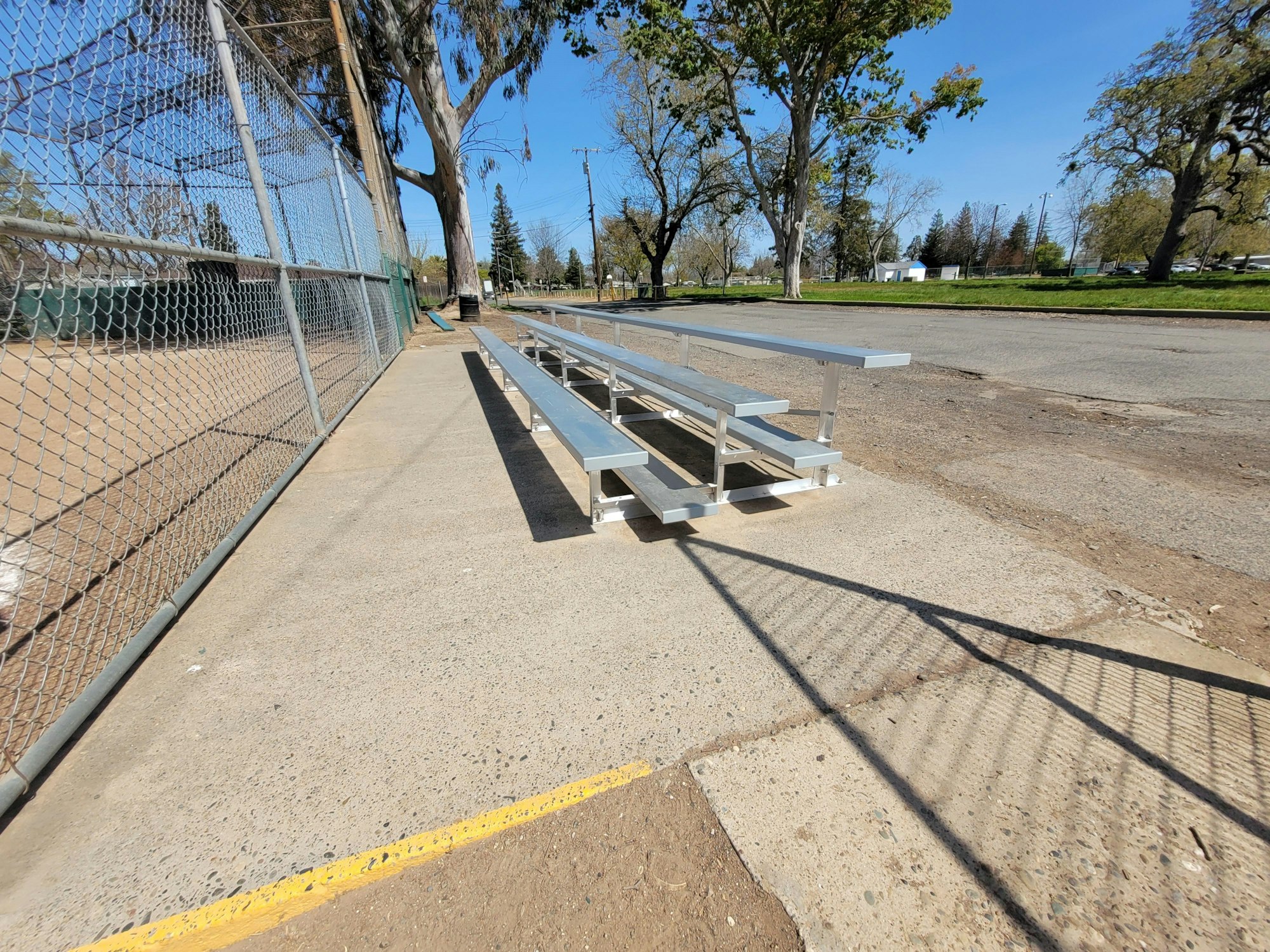 May contain: path, sidewalk, bench, furniture, road, car, transportation, and vehicle