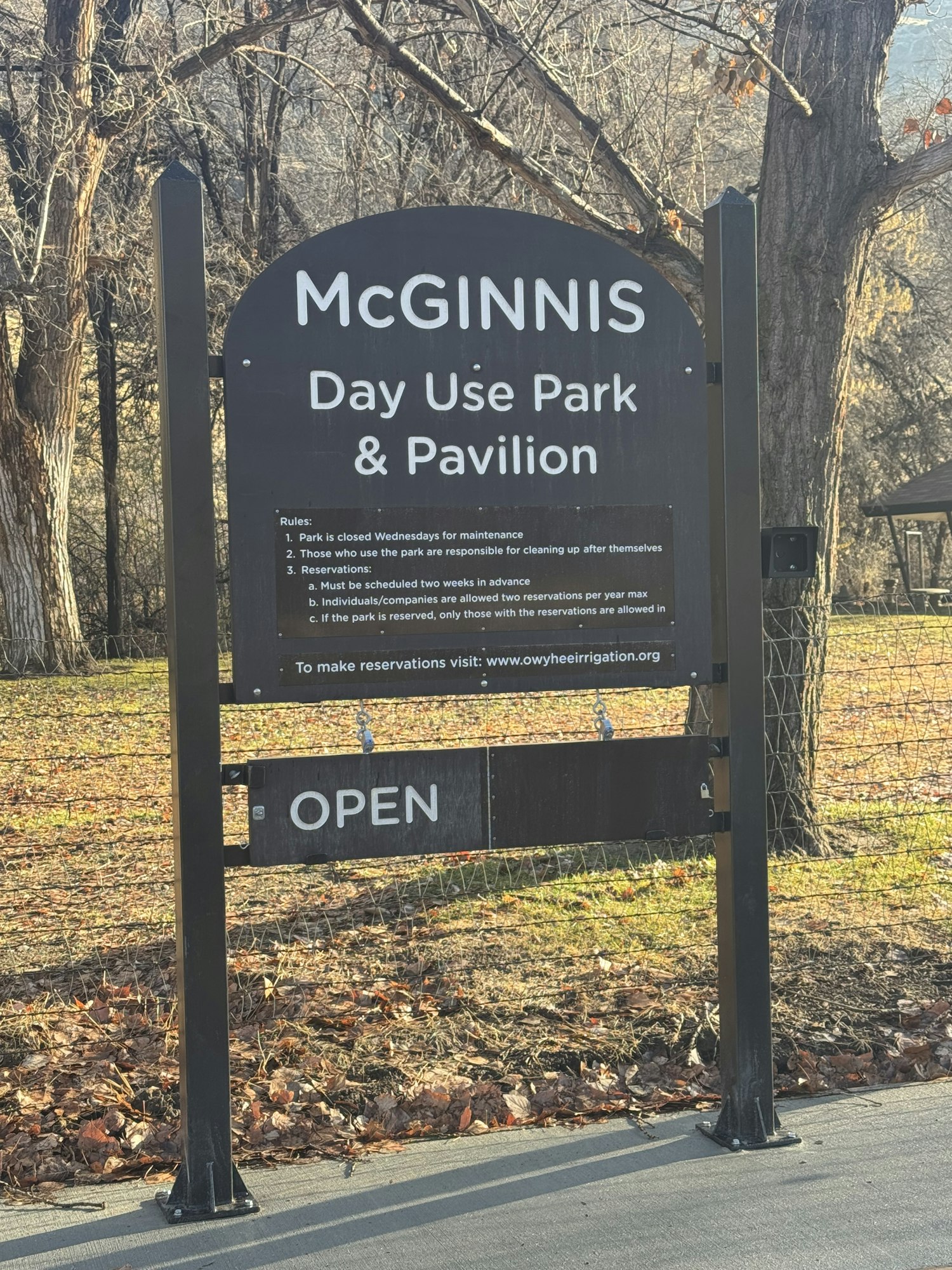 Sign for McGinnis Day Use Park & Pavilion, with rules, website, and "OPEN" status.