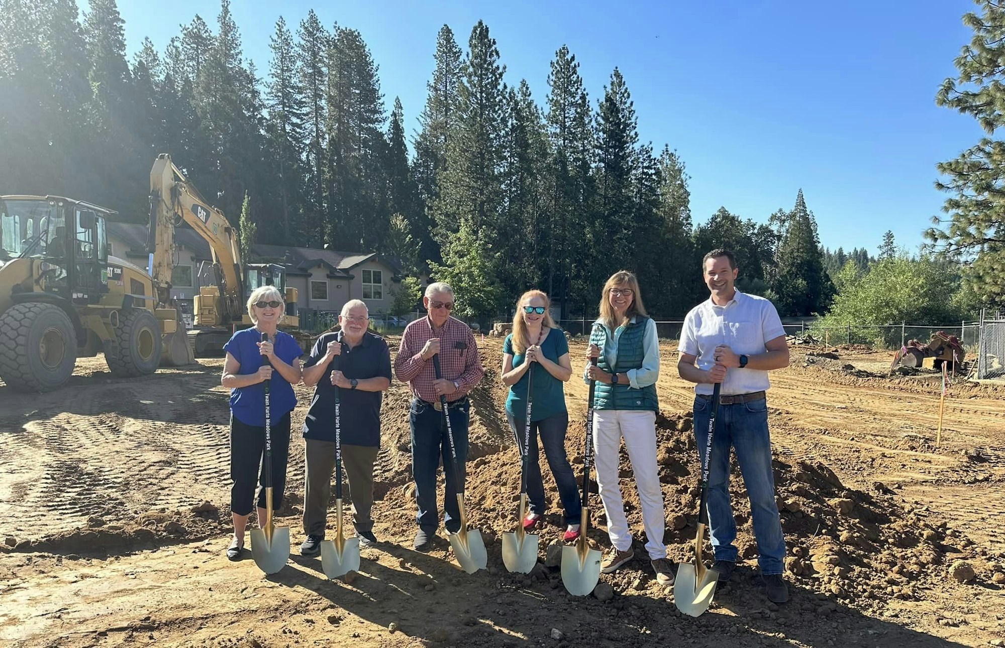 May contain: groupshot, person, outdoors, nature, device, shovel, and tool