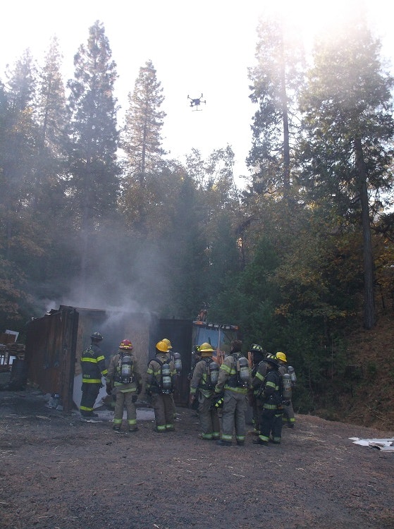 May contain: person, human, fireman, apparel, helmet, smoke, nature