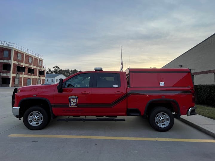 A red fire department truck labeled "Montgomery County," parked in front of a brick building.