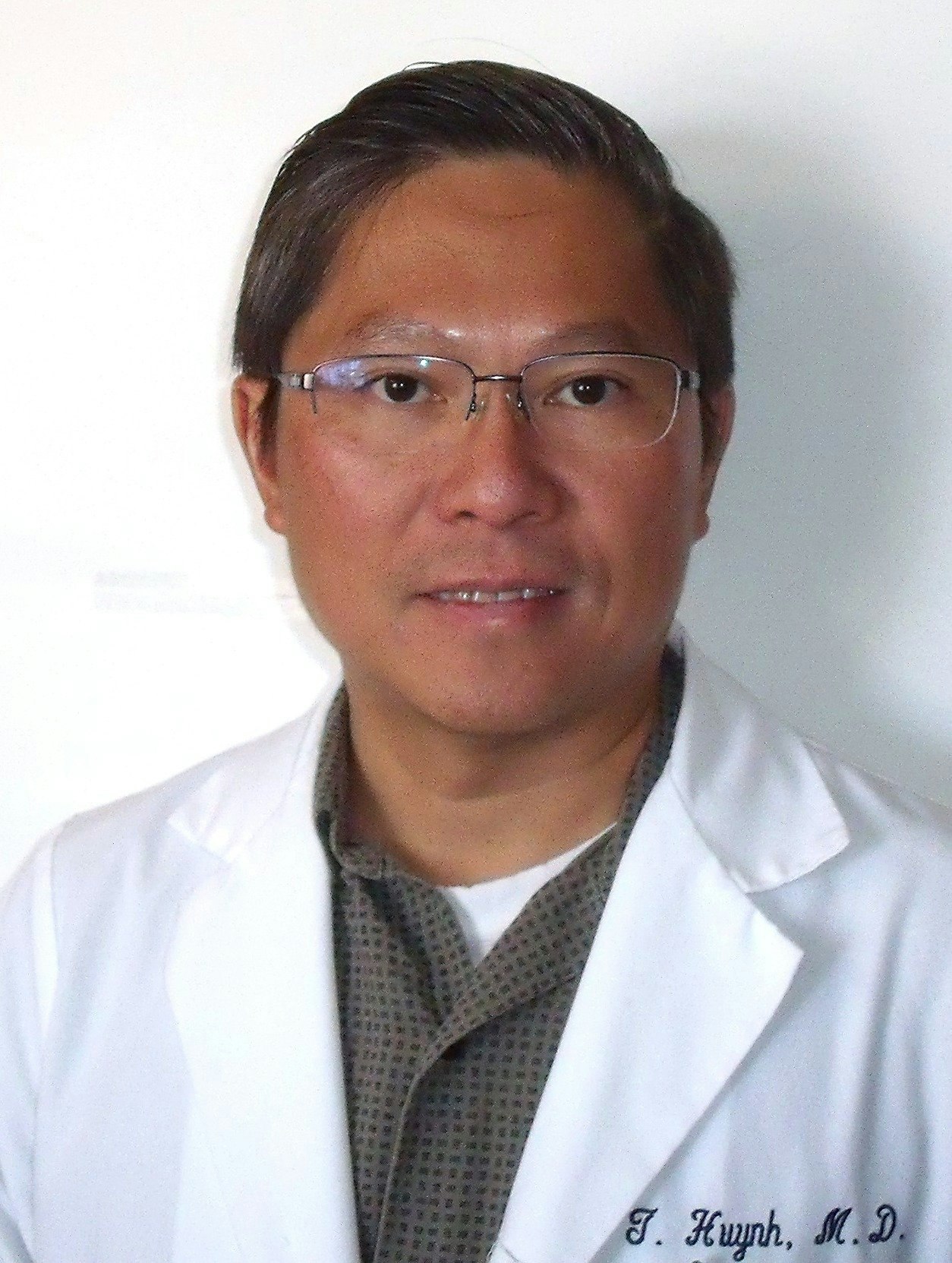 May contain: coat, clothing, person, glasses, accessories, portrait, face, photography, head, shirt, and lab coat