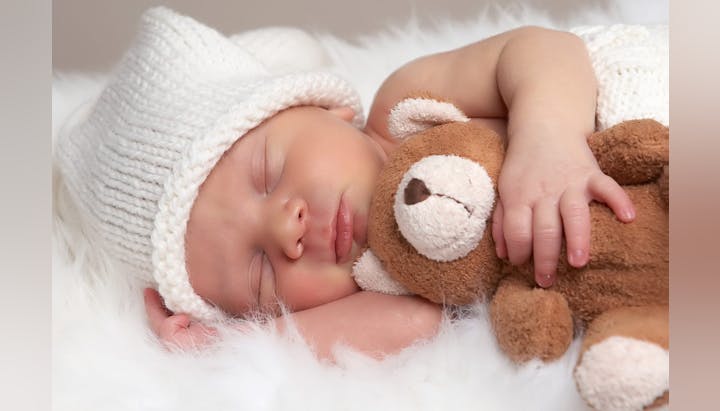 May contain: sleeping, person, newborn, baby, portrait, photography, head, face, hat, and clothing
