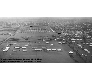 Aerial view of flooded area after Hurricane Carla, showing buildings and roads submerged in water, dated September 12, 1961.