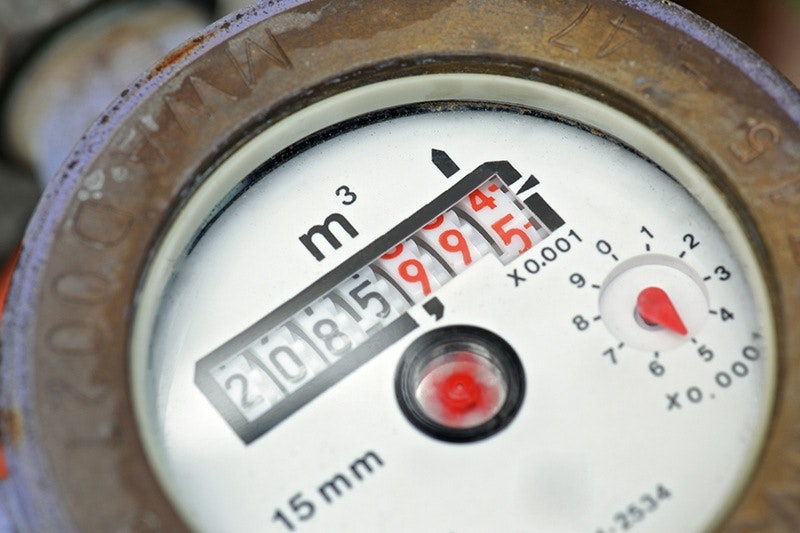 Close-up of a water meter gauge showing usage.