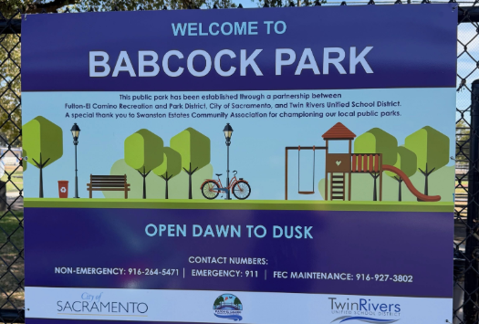 Sign welcoming visitors to Babcock Park, outlining partnerships, hours (dawn to dusk), and contact information for emergencies.