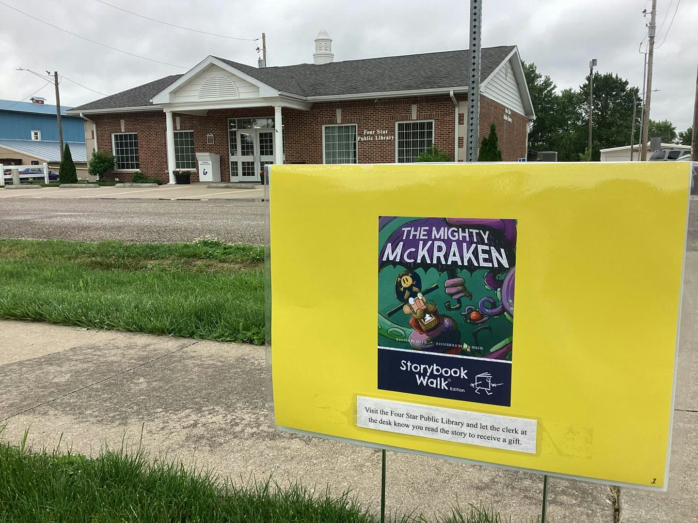 Sign for "The Mighty McKraken" storybook walk near Four Star Public Library.