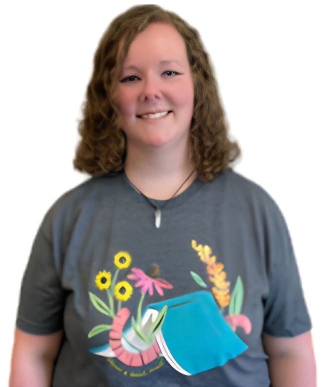The image features a smiling person wearing a gray t-shirt with colorful flower and book designs.