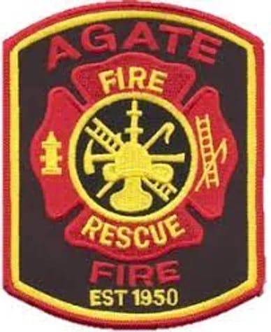 A fire rescue patch with "Agate Fire Rescue" and "EST 1950," featuring firefighting symbols like a hydrant and ladder.