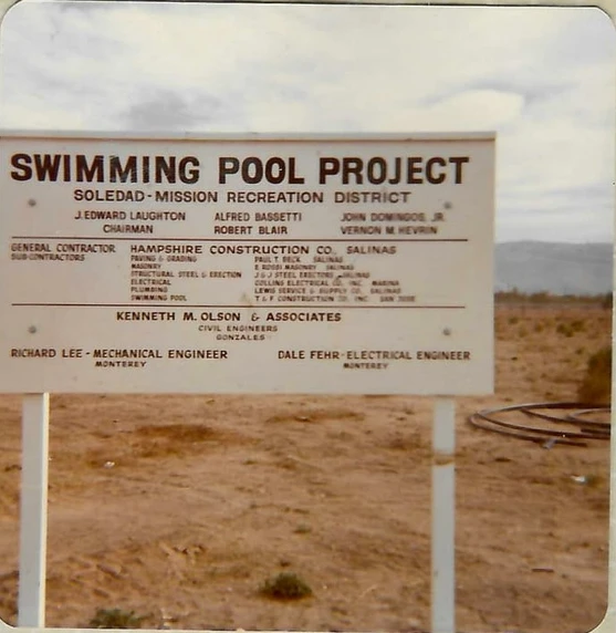 A sign for a swimming pool project by Soledad-Mission Recreation District with names of contributors and engineers.