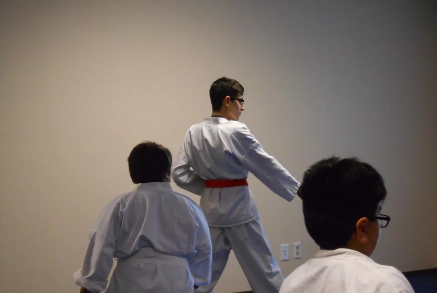 People practicing martial arts in a dojo.