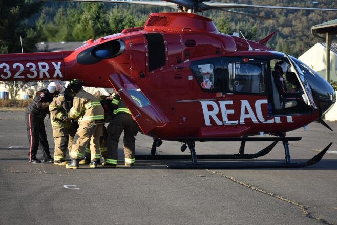 May contain: helicopter, aircraft, vehicle, transportation, person, human, helmet, clothing, and apparel