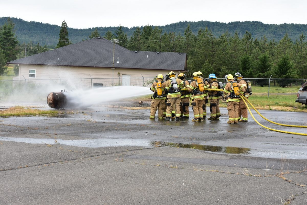 May contain: person, human, fireman, car, transportation, vehicle, automobile, helmet, clothing, and apparel