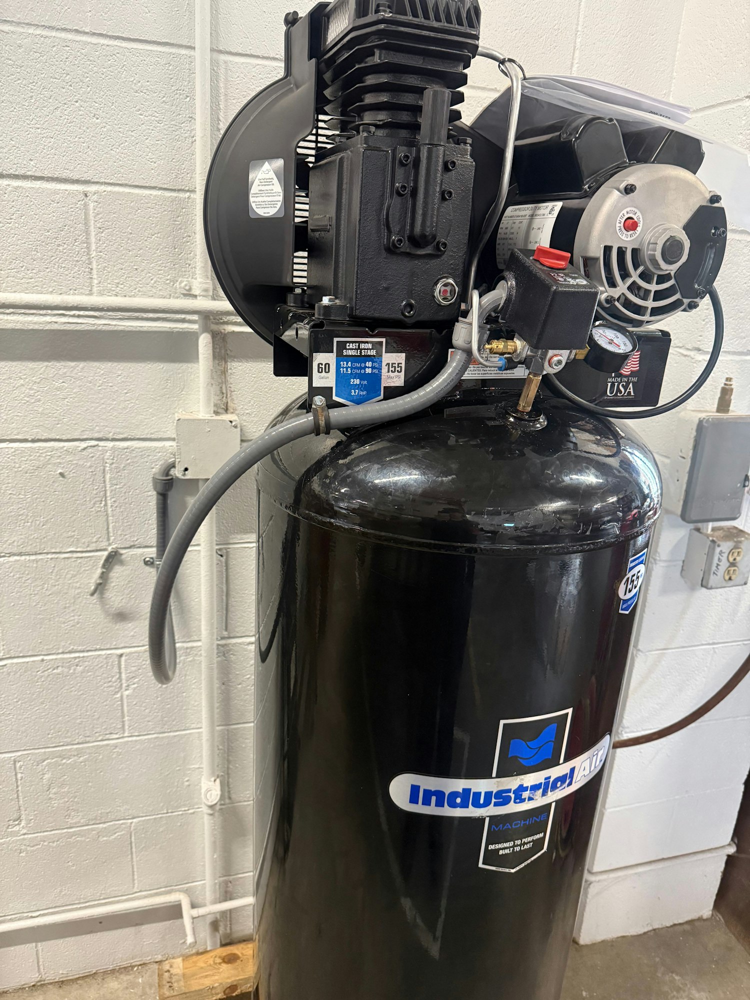 An industrial air compressor with gauges and controls, labeled "Industrial Air."
