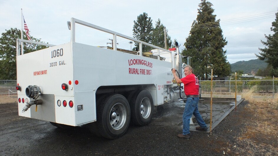 May contain: truck, vehicle, transportation, person, human, pants, clothing, apparel, shoe, and footwear