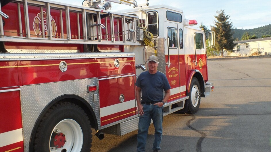 May contain: person, human, jeans, clothing, pants, denim, apparel, truck, vehicle, transportation, wheel, machine, and fire truck