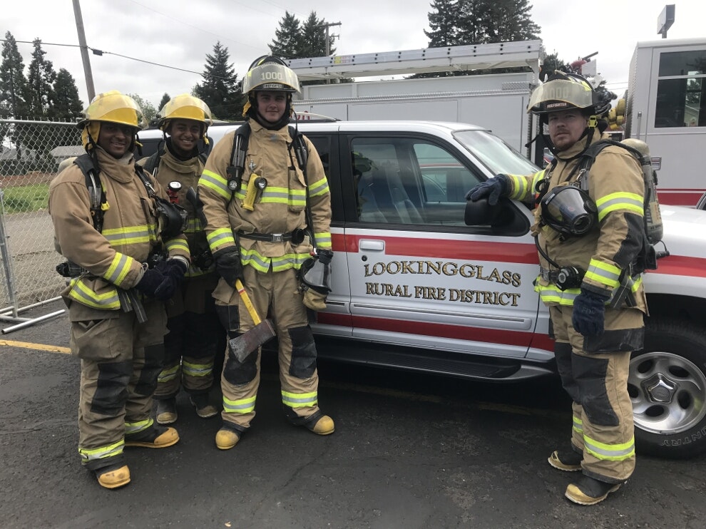 May contain: fireman, person, human, helmet, clothing, apparel, shoe, footwear, car, transportation, vehicle, automobile, wheel, and machine