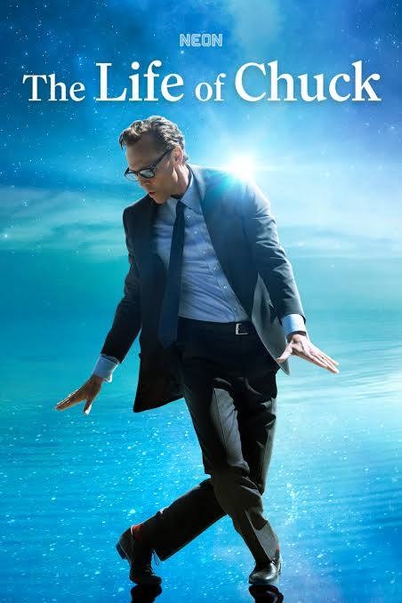A person in a suit dances on water under a bright sky, with the text "The Life of Chuck" at the top.