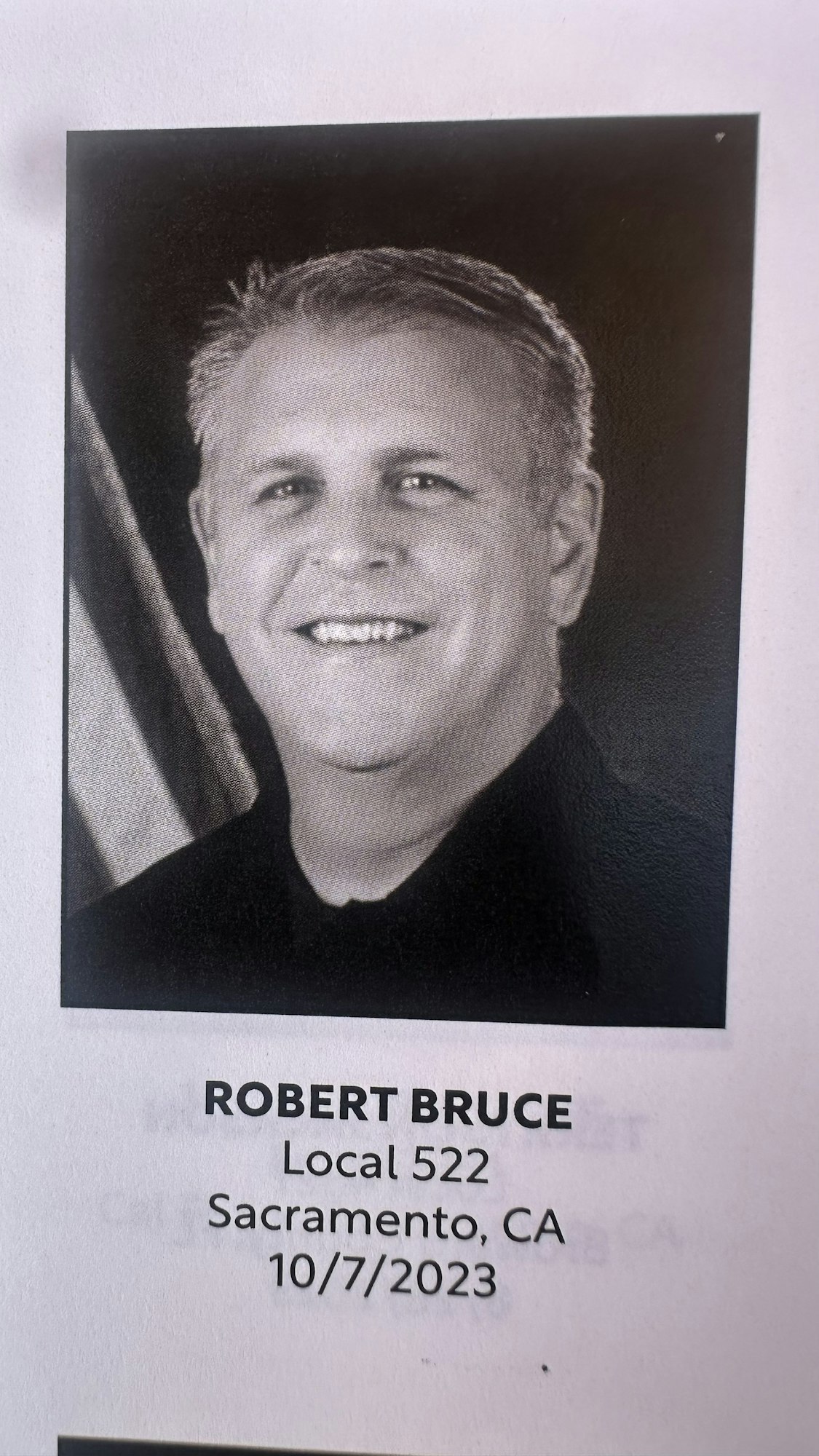 A monochrome portrait of a smiling man, with text indicating a name, association with "Local 522," location as Sacramento, CA, and date 10/7/2023.