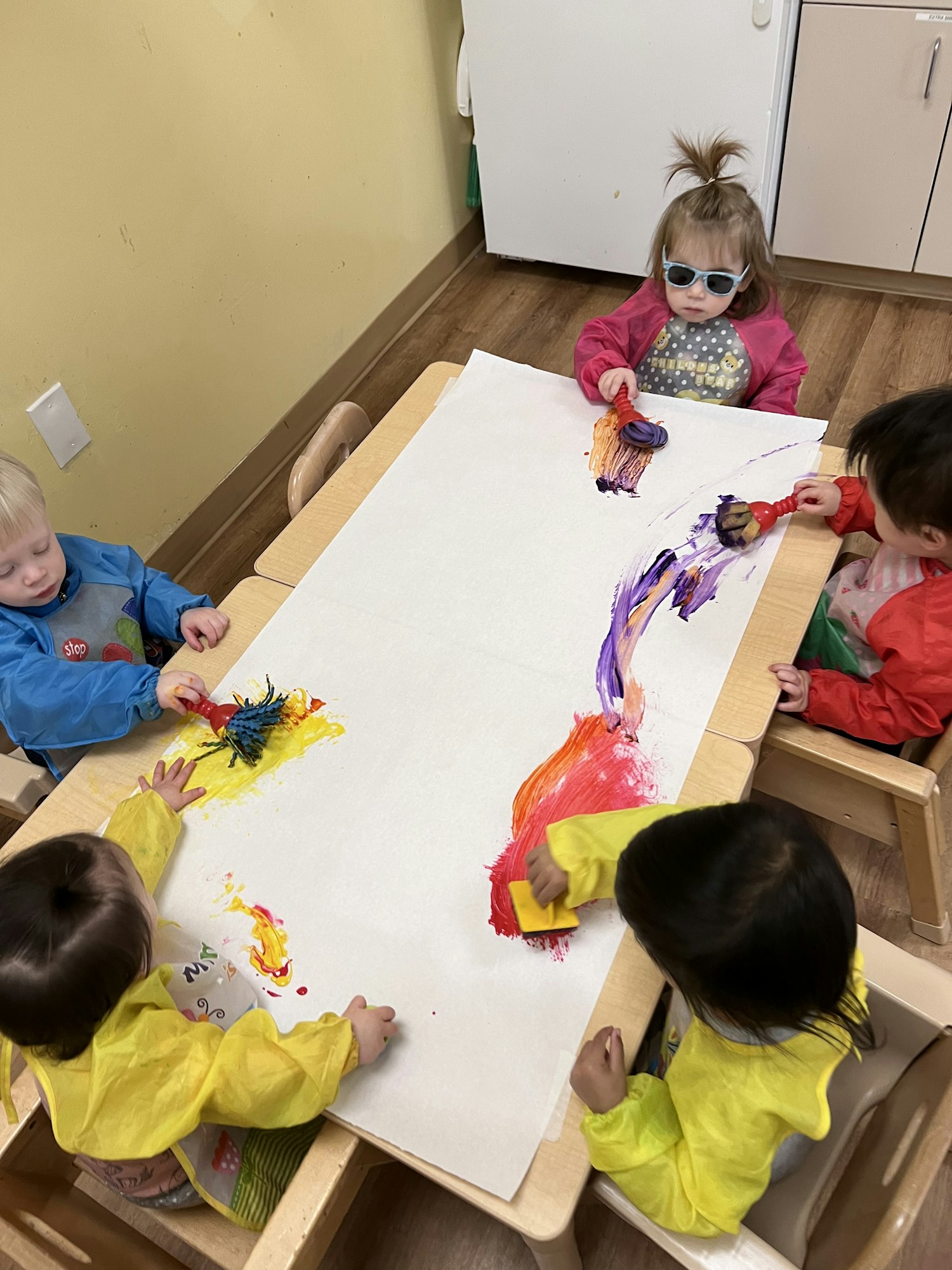 May contain: wood, child, female, girl, person, floor, kindergarten, accessories, glasses, and plywood