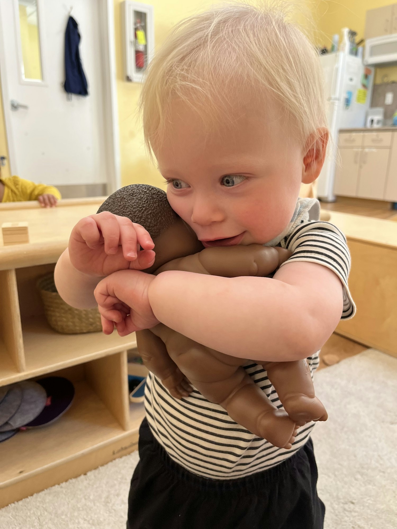 May contain: wood, baby, person, human, shelf, and flooring