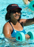 May contain: water, swimming, sports, sport, person, human, apparel, clothing, pool, and female