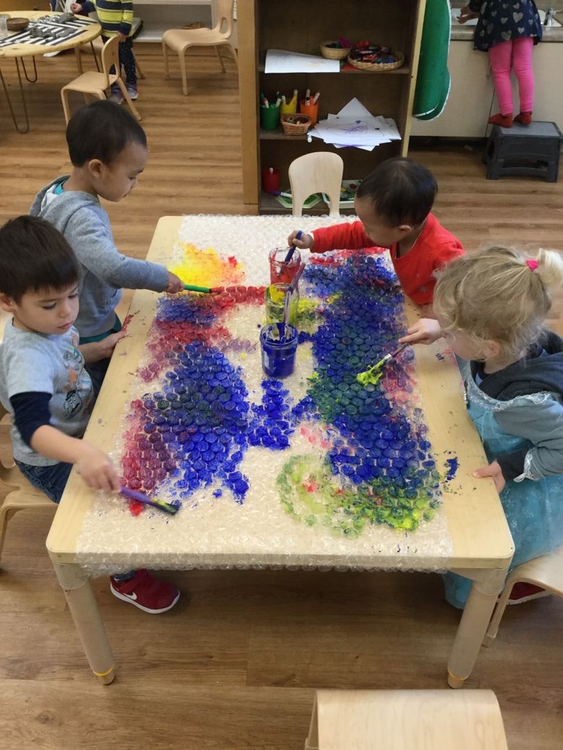 Children at table doing arts and crafts