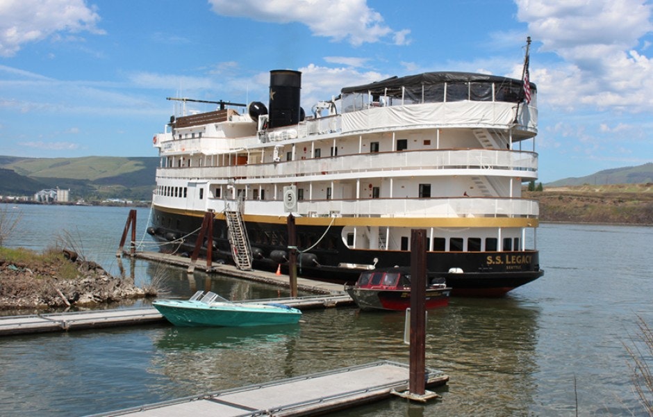 A large boat docked at the marina