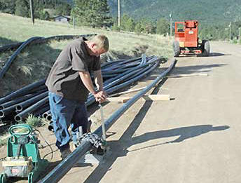 Photo of construction worker laying pipe