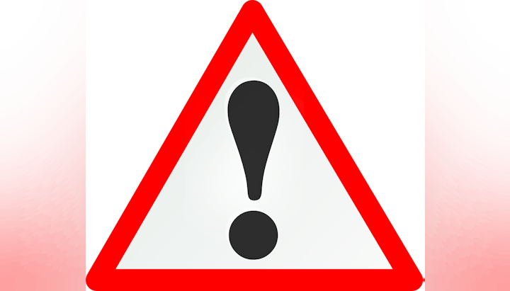 A triangular road warning sign with a black exclamation mark on a white background with a red border.