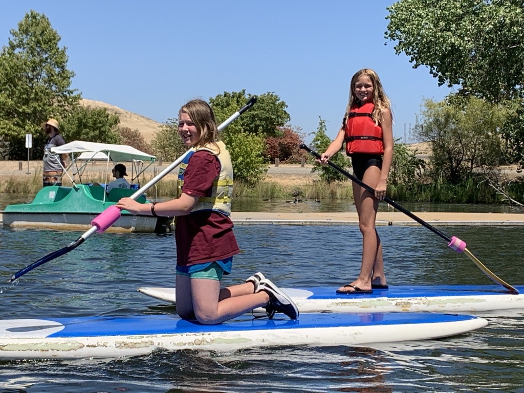 May contain: oars, person, human, paddle, clothing, apparel, lifejacket, vest, rowboat, transportation, vehicle, and boat
