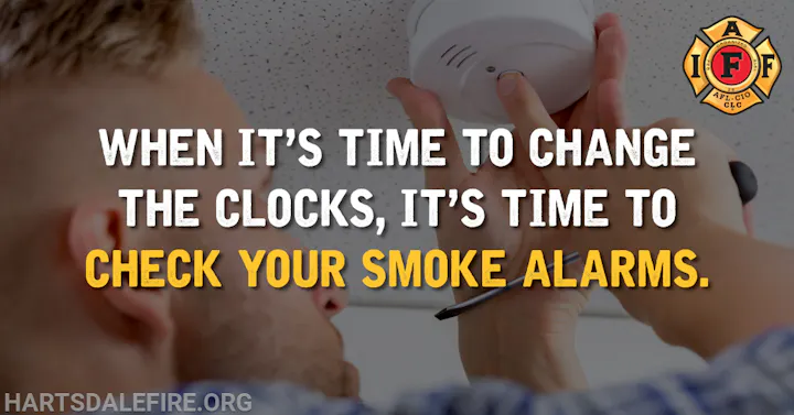 Man checking smoke alarm with the text: "When it’s time to change the clocks, it’s time to check your smoke alarms."