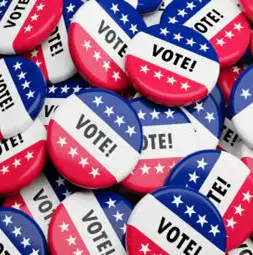 A collection of buttons featuring red, white, and blue colors with the word "VOTE!" prominently displayed.