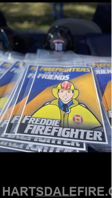 The image features promotional materials for "Freddie Firefighter," possibly aimed at children, with a cartoon firefighter character.