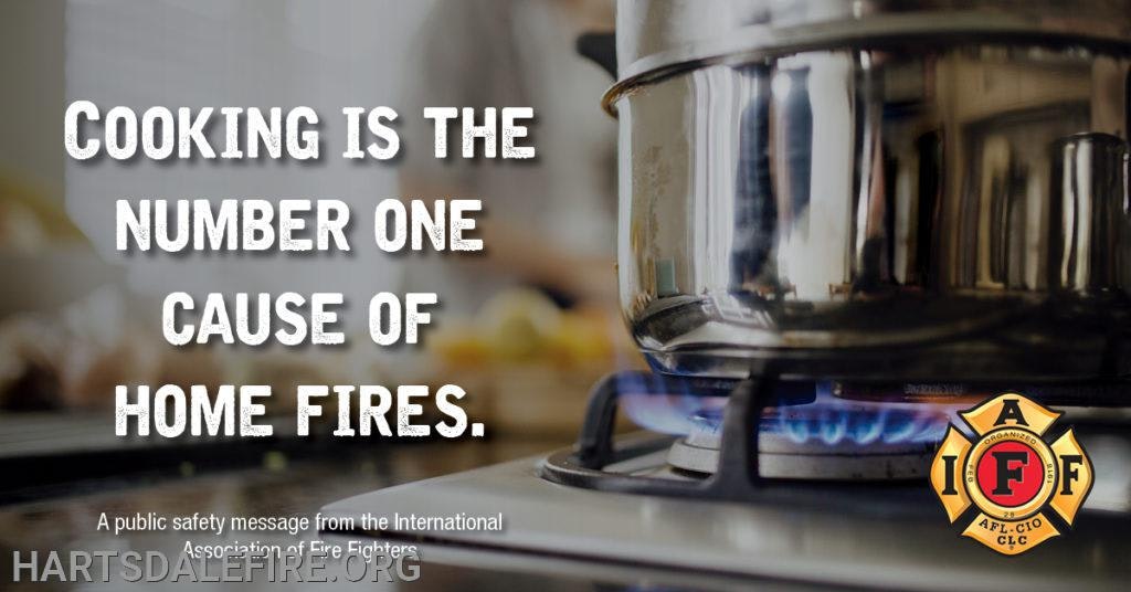 Pot on a stove with flame; text: "Cooking is the number one cause of home fires." Public safety message by fire fighters.