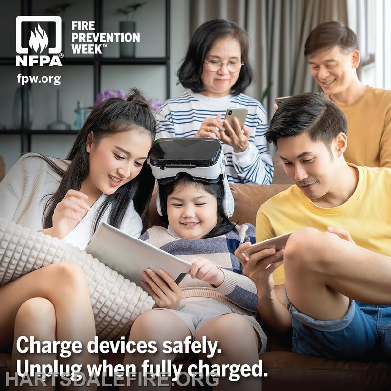A family enjoys tech together. Message emphasizes safe device charging and unplugging when fully charged.