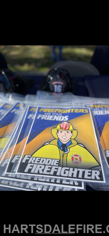 The image features several cards with a cartoon firefighter named Freddie, promoting fire safety and friendship.