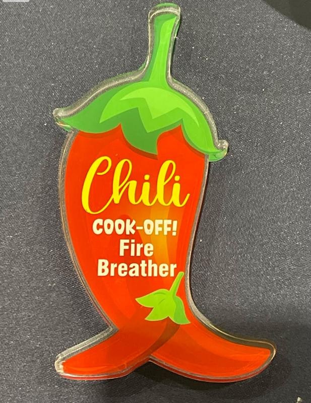 It's a chili pepper-shaped sign for a "Chili Cook-Off" event, with "Fire Breather" written on it.