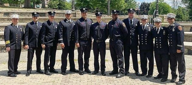 A group of people in uniform standing together outdoors.