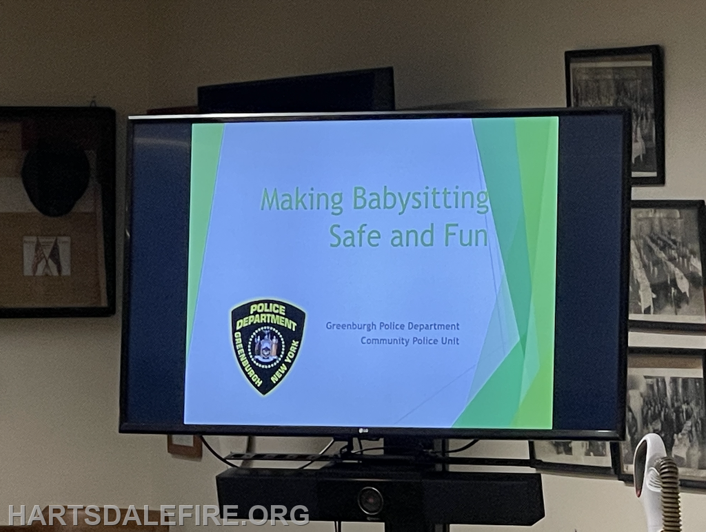 Presentation titled "Making Babysitting Safe and Fun" by Greenburgh Police Department is displayed on a screen.
