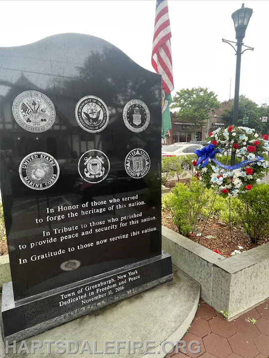 A memorial in Greenburgh, NY, honoring military service and sacrifice, dedicated on November 11, 2016, with wreaths and emblems.
