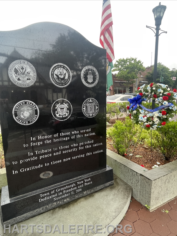 A memorial in Greenburgh, NY, honoring military service and sacrifice, dedicated on November 11, 2016, with wreaths and emblems.