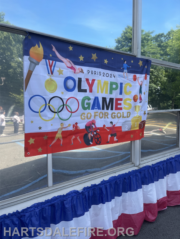 A colorful banner promoting the Paris 2024 Olympic Games with the slogan "Go for Gold."