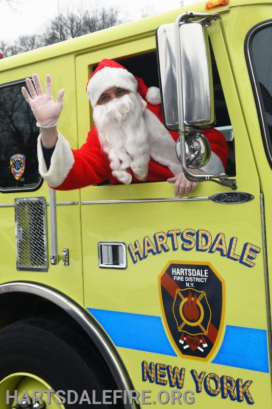 Santa Claus waving from a Hartsdale, New York fire truck.
