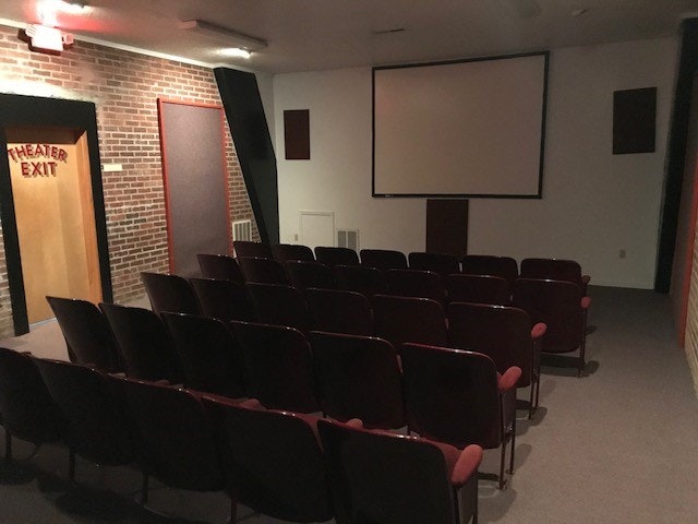 May contain: people, person, school, building, architecture, indoors, classroom, room, crowd, lecture, audience, hall, lamp, and lecture hall