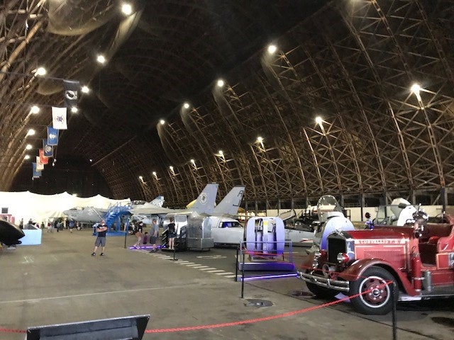 May contain: person, car, vehicle, transportation, hangar, building, architecture, airport, airplane, and aircraft