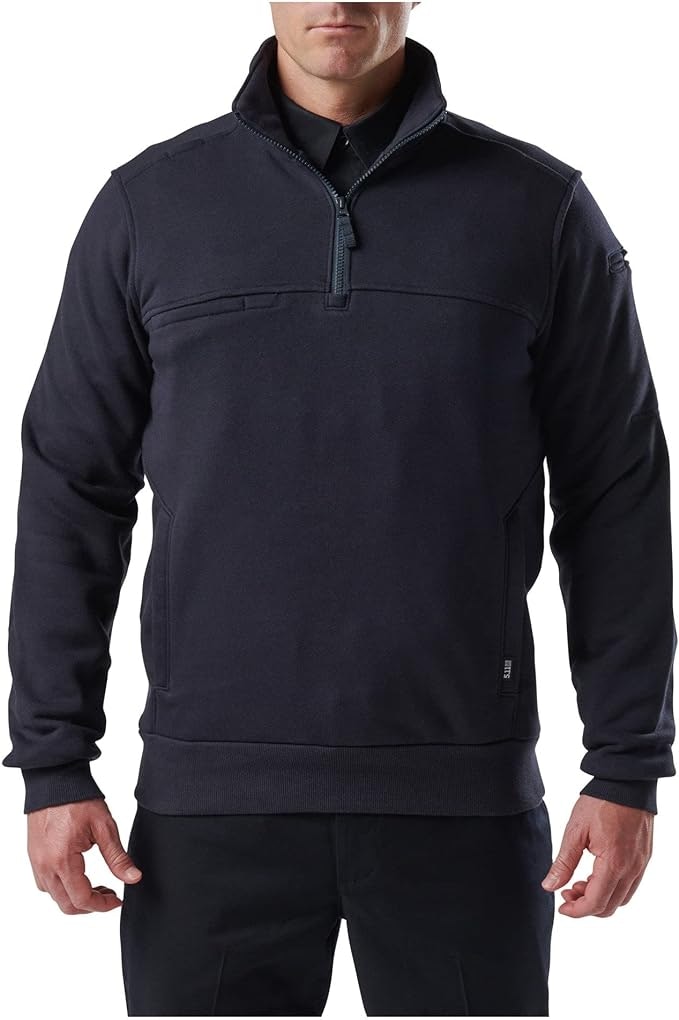 Person wearing a navy blue pullover with a zippered neck.