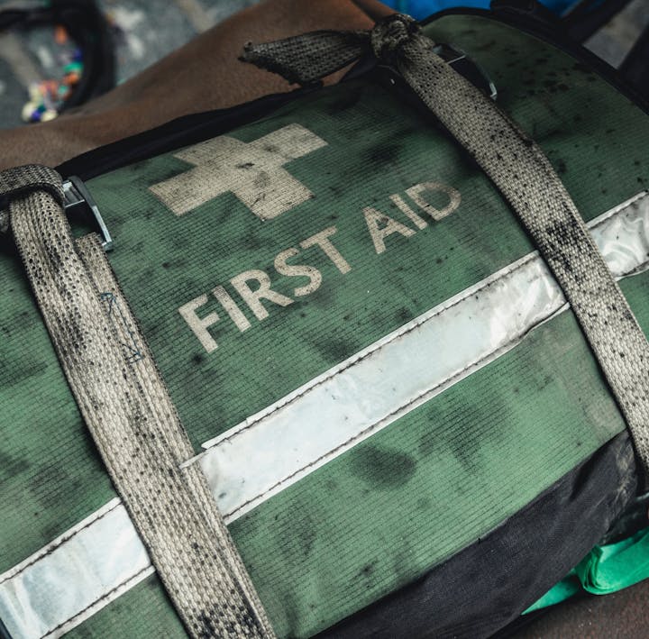 green first aid bag with white cross