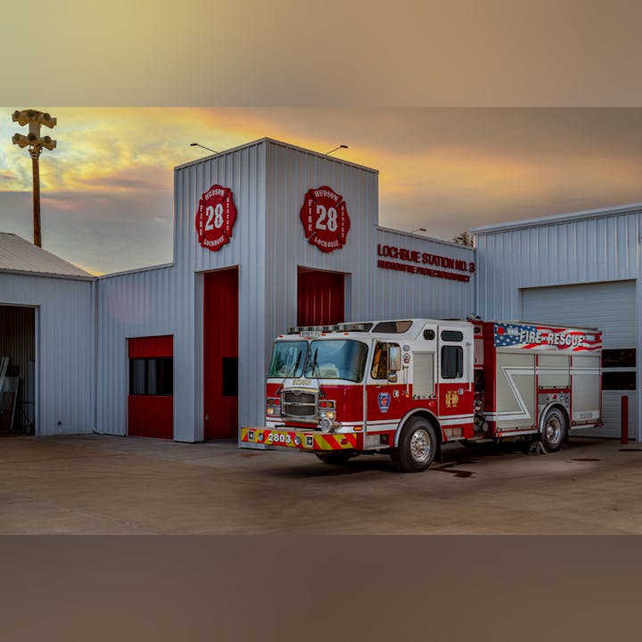 Fire truck parked outside Lochbuie Fire Station No. 3 at sunset.
